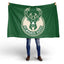 Person holding a green Milwaukee Bucks flag on a white background