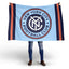 Person holding a New York City Football Club blanket with the club's logo.