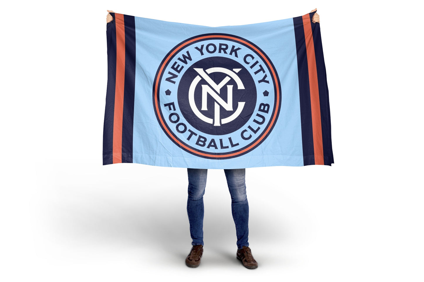 Person holding a New York City Football Club blanket with the club's logo.
