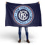 Person holding a New York City Football Club flag on a white background