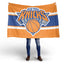 Person holding a New York Knicks flag on a white background