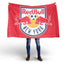 Person holding a Red Bull New York flag against a white background