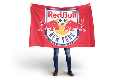 Person holding a Red Bull New York flag against a white background