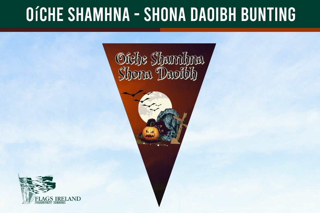A triangular pennant flag design with Halloween-themed artwork, including a full moon, bats, a pumpkin, and a tombstone, with the text 'Oíche Shamhna Shona Daoibh Bunting' at the top. The pennant is centered on a pale blue sky background, with a dark green banner across the top and a small 'Flags Ireland' logo in the lower left.