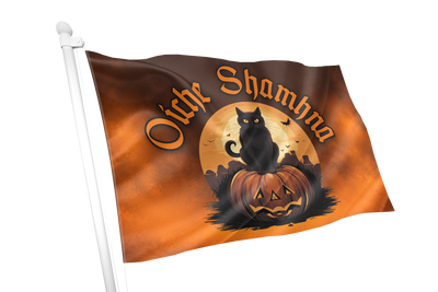 A Halloween-themed flag on a white pole, featuring the words 'Oink Shamna' in orange lettering above a black cat sitting on a carved pumpkin against an orange and brown gradient background.