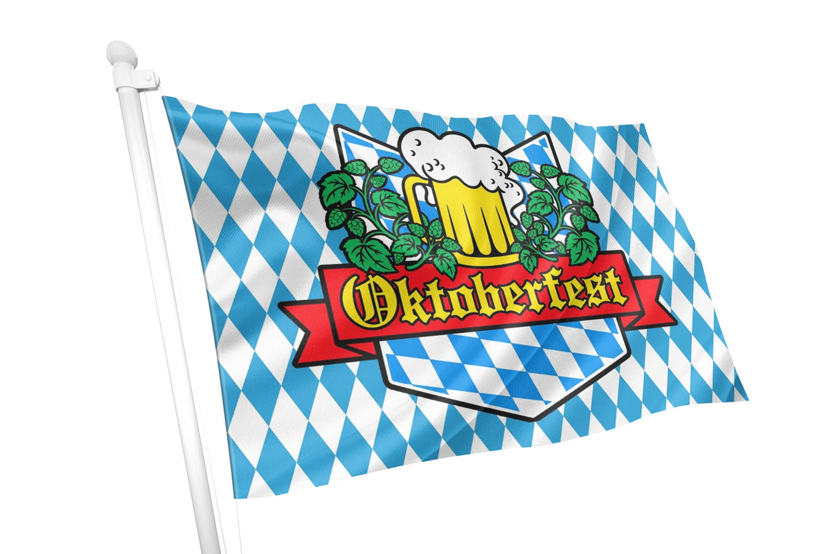 A Bavarian Oktoberfest flag on a white pole, featuring the traditional blue and white checkered pattern with a central emblem of a beer mug, hops, and a red banner reading 'Oktoberfest'.