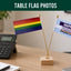 Two small flags on a desk with 'Happy Pride Month' message and 'Flags Ireland' branding.