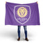 Person holding a purple Orlando City flag with a lion emblem on a white background