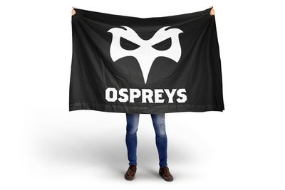Person holding a black flag with 'Ospreys' logo on a white background