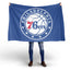 Person holding a Philadelphia 76ers flag on a white background