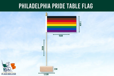 Philadelphia Pride flag on a wooden stand against a pastel striped background