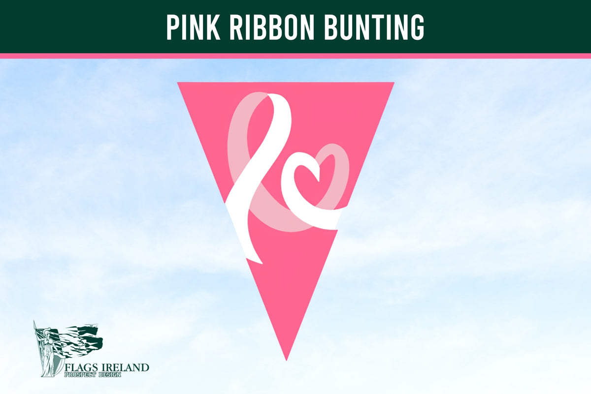 A pink triangular bunting flag with a white ribbon and heart design, shown against a light blue sky background. A dark green banner at the top reads 'PINK RIBBON BUNTING' and a 'Flags Ireland' logo is visible in the bottom left corner. Breast Cancer Bunting.