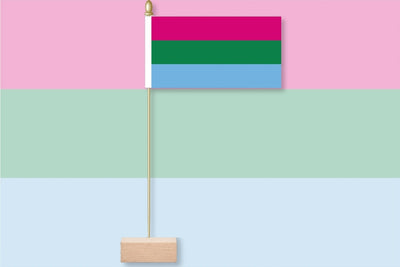 Polysexual Flag with pink, green, and blue stripes on a pink and light blue gradient background