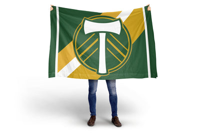 Person holding a green and yellow flag with a logo on a white background. Portland Timbers FC Stripes Flag.