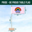 Pride-themed table flag with rainbow design and text 'PRIDE be proud' on a blue background.