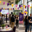 Event or conference with people networking, colorful bunting flags, and promotional banners.
