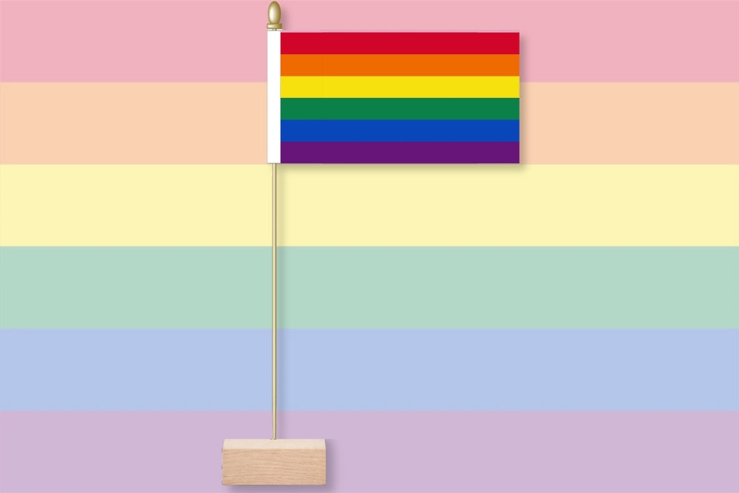 Rainbow flag on a pastel raibow colours background