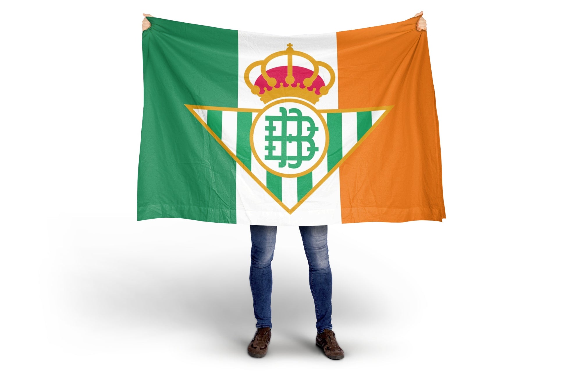 Person holding a Flag with a Real Betis logo featuring a crown and a letter 'B' on a green, white, and orange irish Flag background.