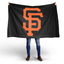 Person holding a black flag with an orange 'SF' logo on a white background