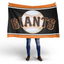 Person holding a Giants baseball flag on a white background