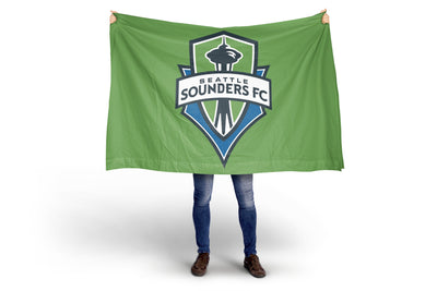 Person holding a green Seattle Sounders FC flag against a white background