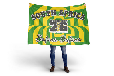 Person holding a South Africa World Cup 2026 flag with green and yellow stripes.