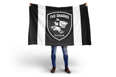 Person holding a black and white flag with 'The Sharks Durban' logo on a white background