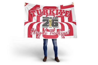 Person holding a red and white flag with Turkish text and World Cup 2026 logo.