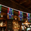 Decorative World Cup 2026 flags hanging in a bar with wooden beams and lighting fixtures.