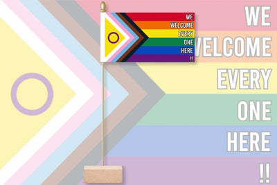 Flag with rainbow design and text 'We welcome everyone here' on a colorful geometric background. We Welcome Every One Here - Intersex Inclusive Pride 