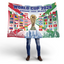 Person holding a World Cup 2026 themed blanket with flags and trophy design.