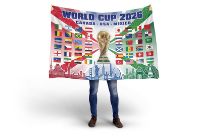 Person holding a World Cup 2026 themed blanket with flags and trophy design.