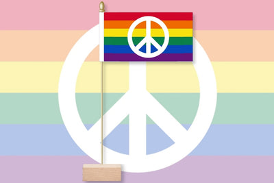 Peace symbol with a rainbow flag on a pastel striped background