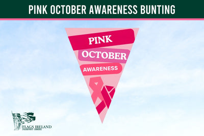 A triangular pink and red pennant flag with the text 'PINK OCTOBER AWARENESS' and a pink ribbon, shown against a light blue sky background. A dark green banner at the top reads 'PINK OCTOBER AWARENESS BUNTING', and the 'Flags Ireland' logo appears in the lower left. Pink October Awareness Bunting. Breast Cancer Bunting.